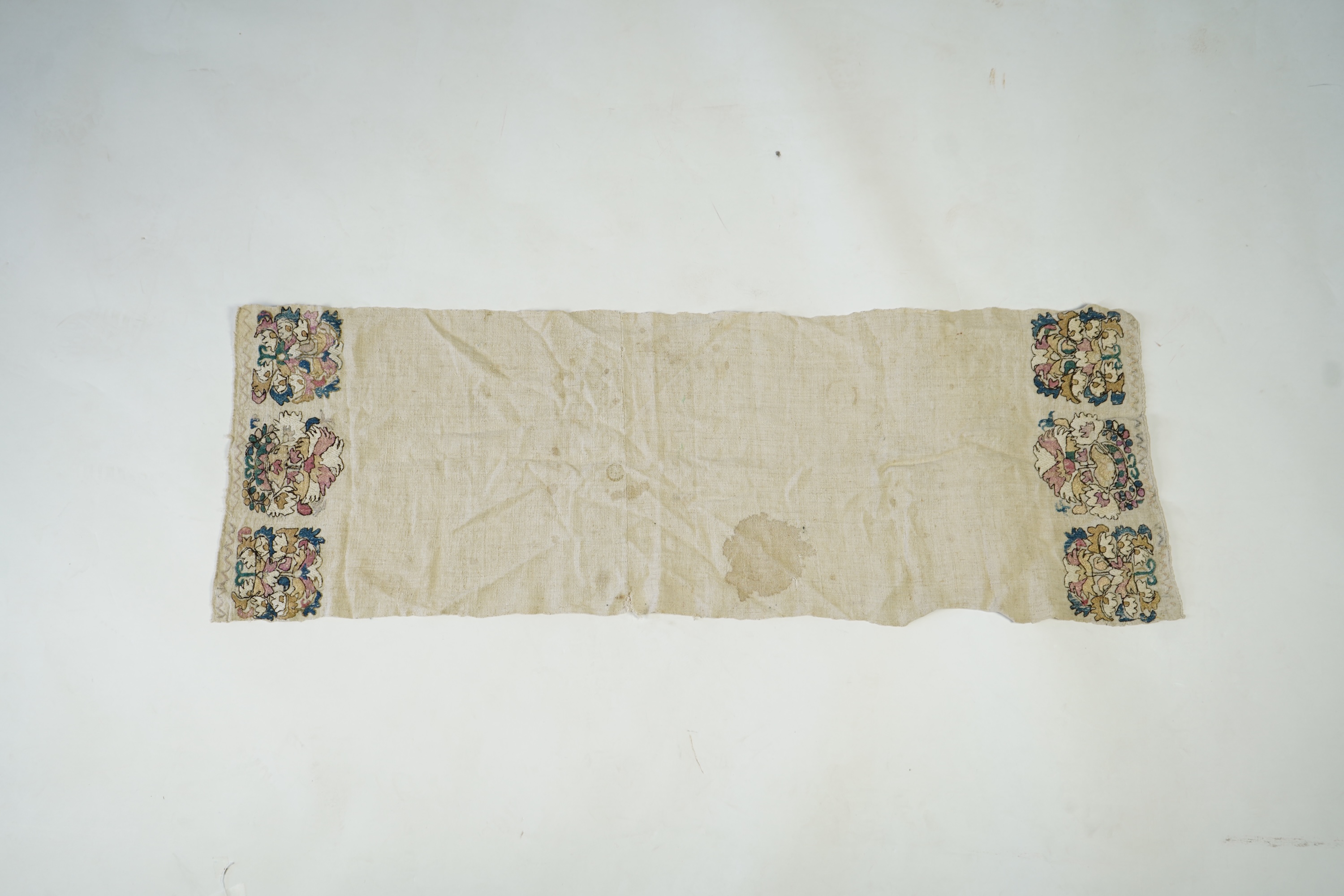 An early 20th century heavy hand woven linen Turkish towel, with coloured silk embroidered ends. 123cm long x 43cm wide. Condition - has two stains and some embroidery worn in places.